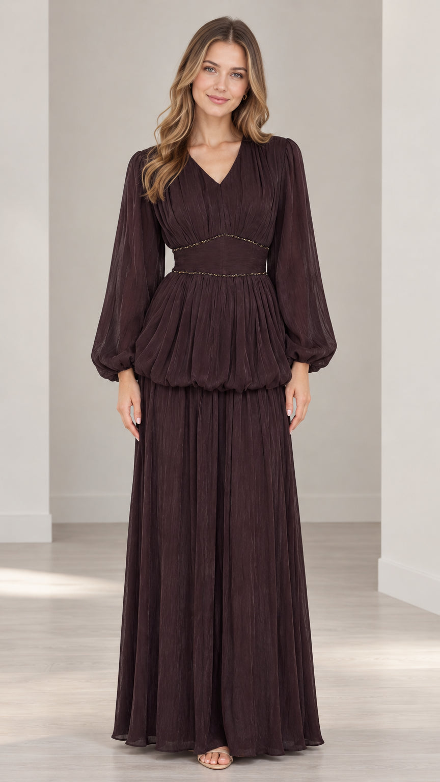 Front full-length view of woman wearing burgundy long sleeve pleated maxi dress