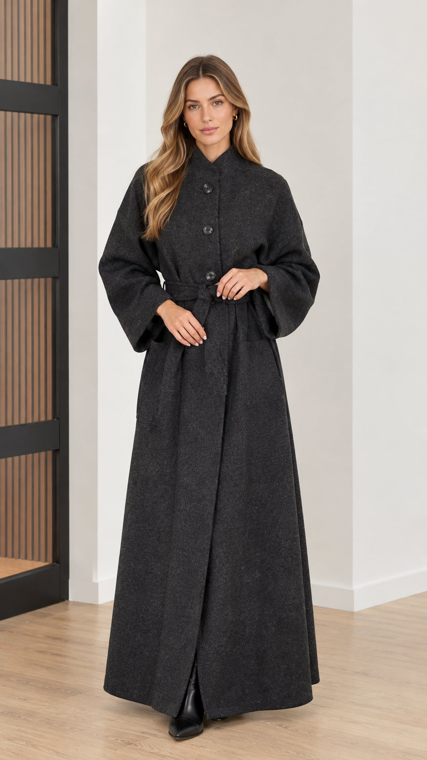 Front view of woman wearing charcoal grey belted maxi overcoat