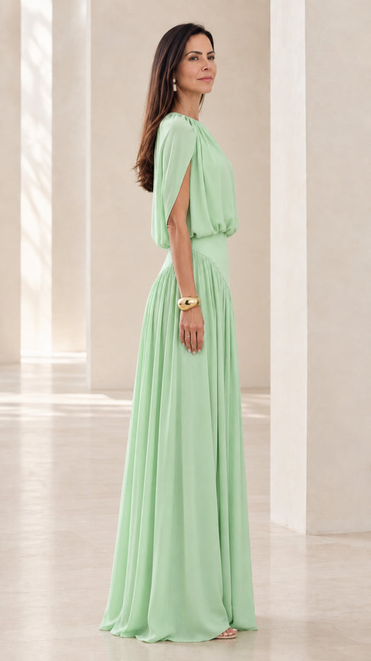 Side view of model wearing Mint Green maxi dress highlighting slit capelet sleeves