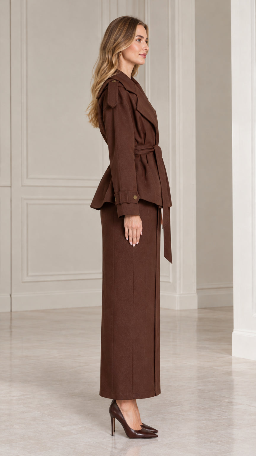 Side view of chocolate brown two-piece peplum jacket and maxi skirt outfit
