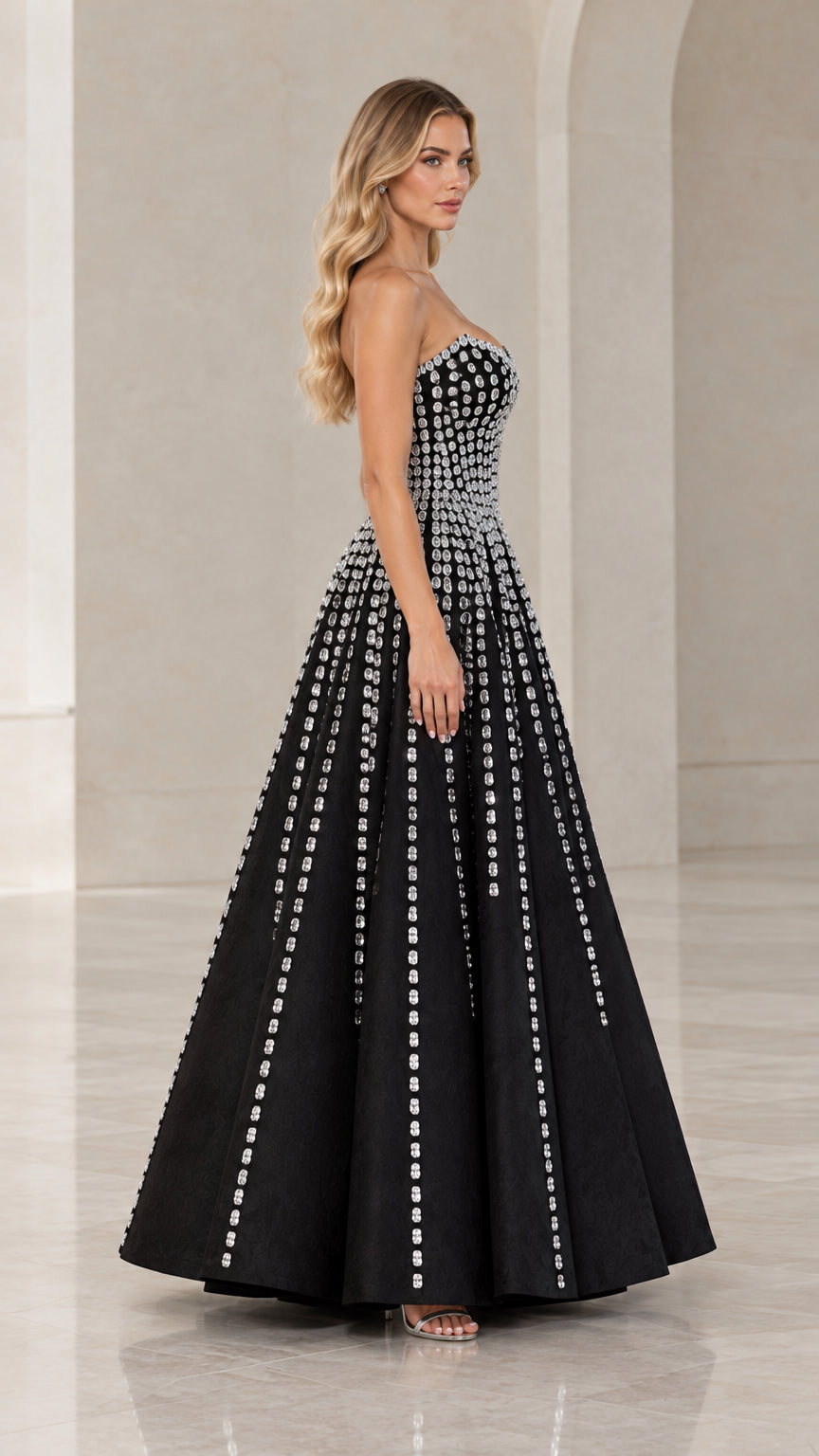 Side profile view of woman wearing black crystal embellished formal ballgown