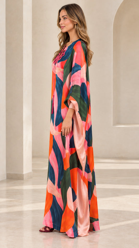 Side profile view of flowing abstract print kaftan dress showing drape and sleeve length