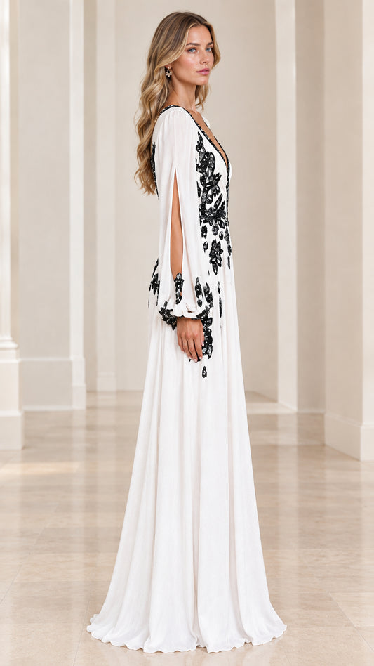 Side profile of model wearing white floor-length embroidered evening dress