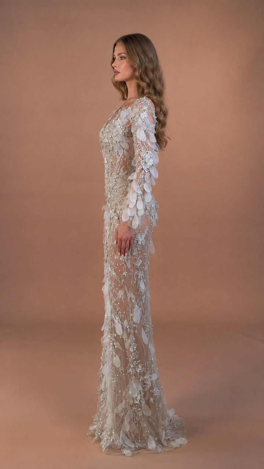 Side profile of model in Champagne Silver embellished long sleeve formal dress