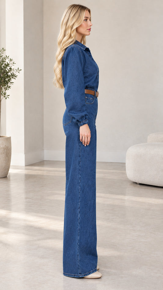 Side profile of model wearing medium blue button-front denim jumpsuit