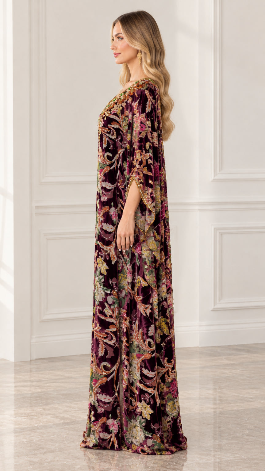 Side profile view of burgundy floral velvet kaftan dress showing draped sleeve