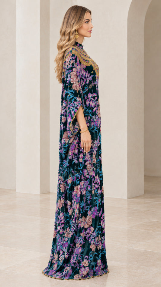 Side profile view of teal floral velvet kaftan showing draped sleeves