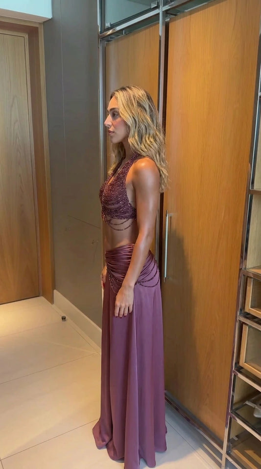 Side angle of model wearing mauve beaded halter two-piece evening set