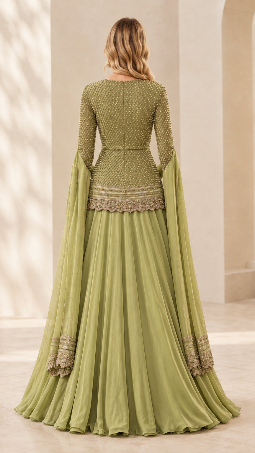 Back view of sage green beaded peplum top and floor-length pleated skirt