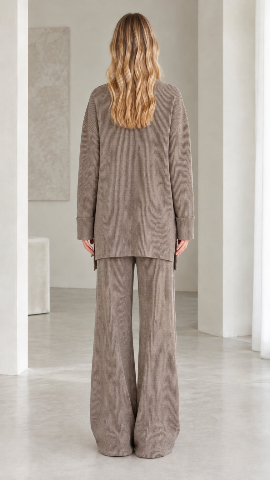 Back view of model wearing relaxed fit taupe ribbed knit two-piece set