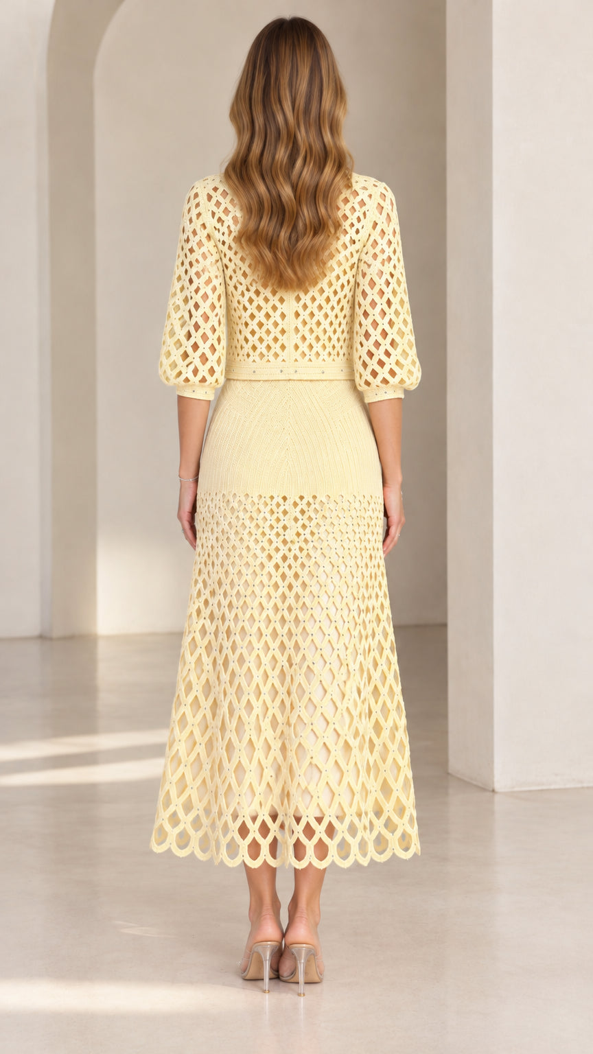 Back view of pale yellow crochet cardigan and midi skirt set