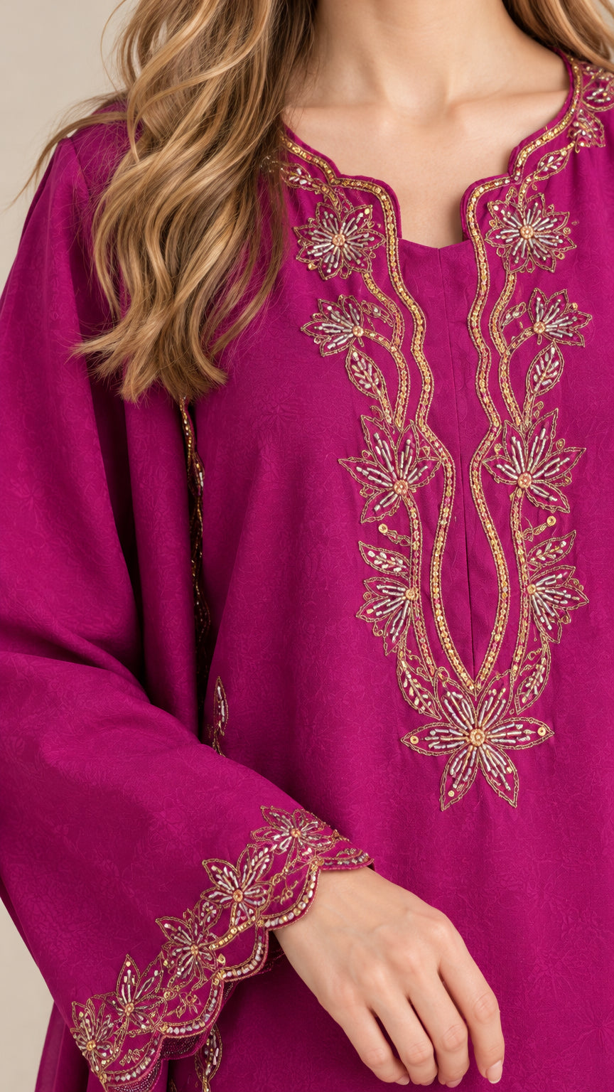 Close-up detail of metallic gold floral embroidery on magenta tunic neckline and scalloped cuff