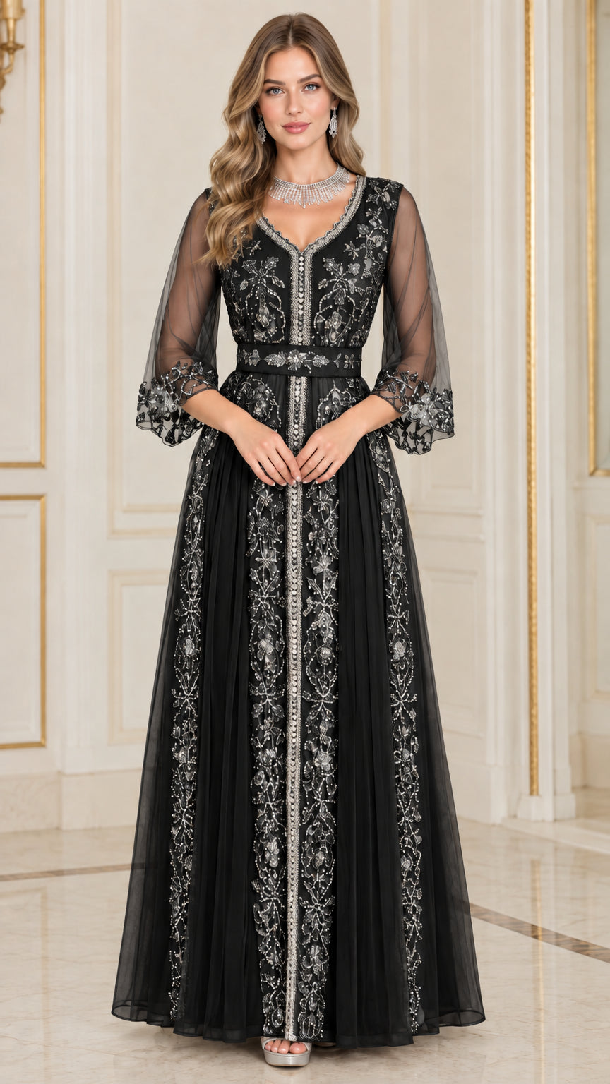 Front full-length view of woman in black embroidered beaded evening gown