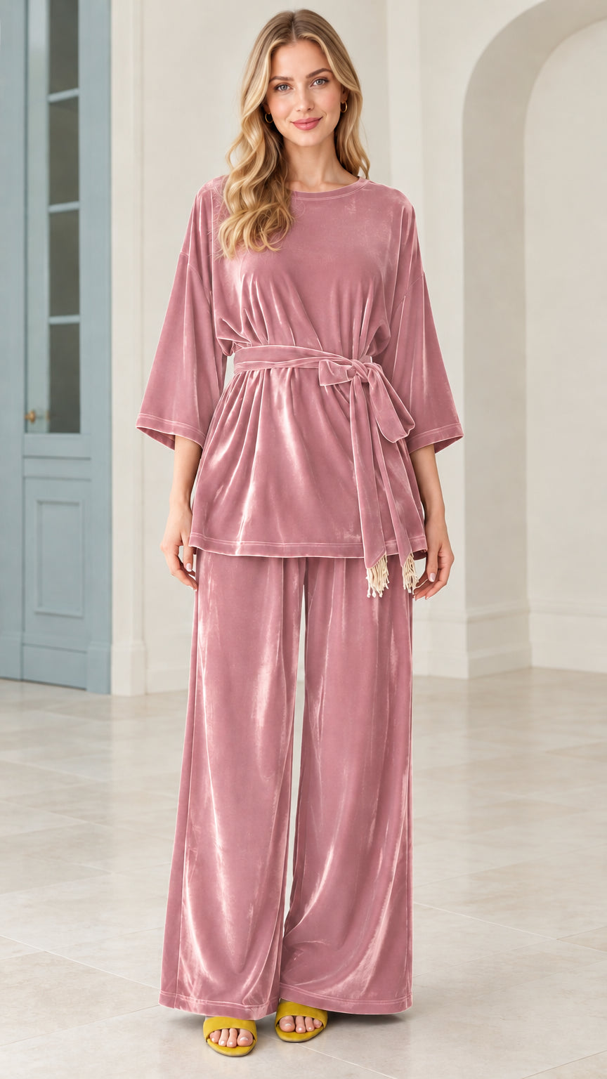 Model wearing dusty pink velvet belted top and wide leg pants matching set