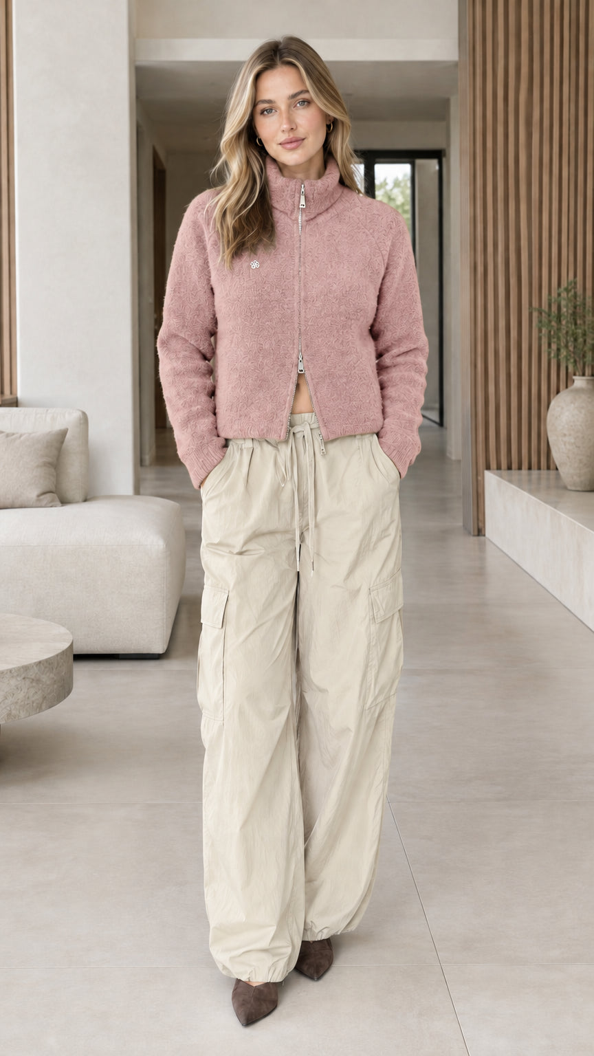 Model wearing dusty pink textured fleece stand collar zip-up jacket