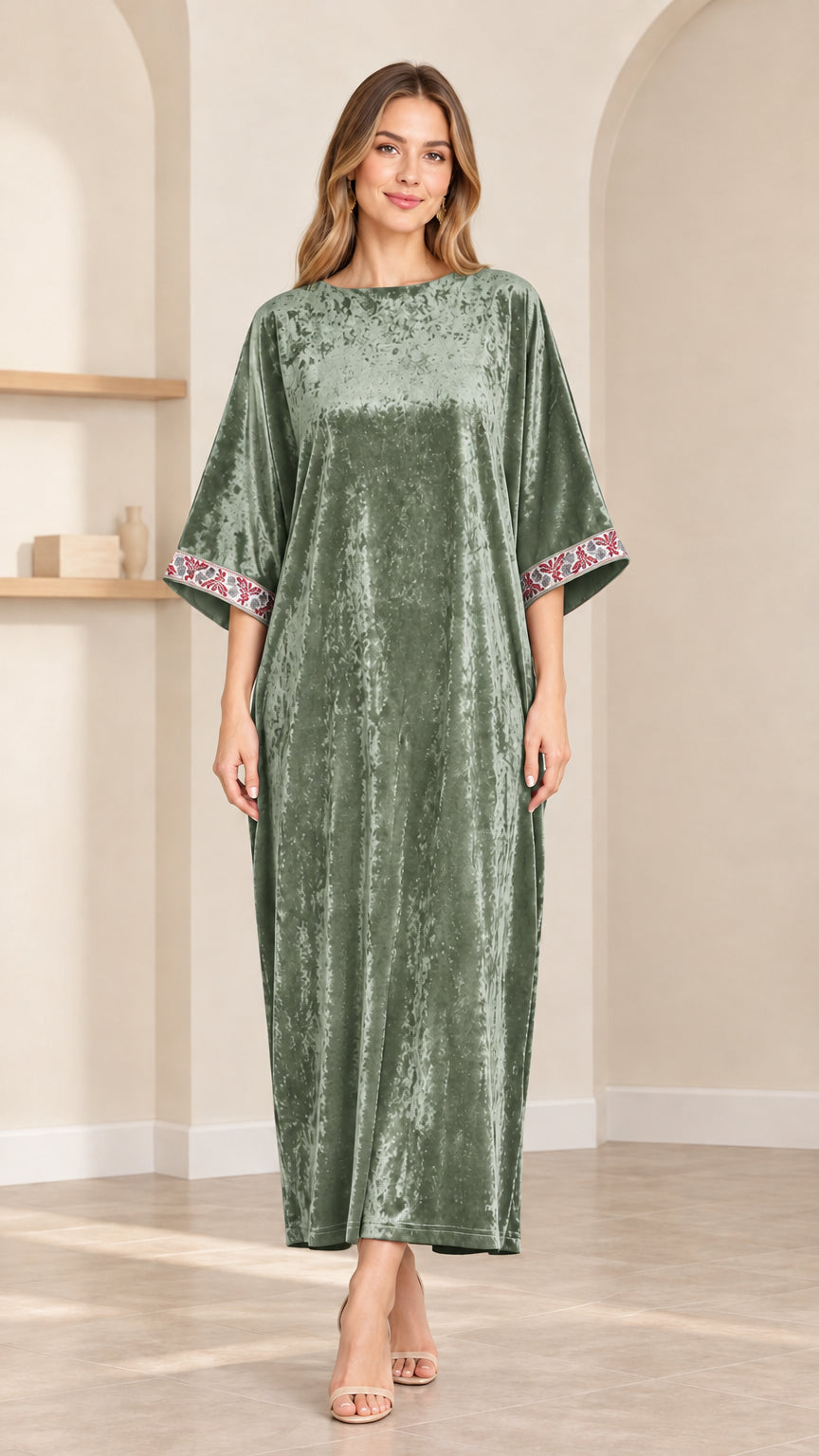 Front view of model wearing sage green crushed velvet kaftan maxi dress