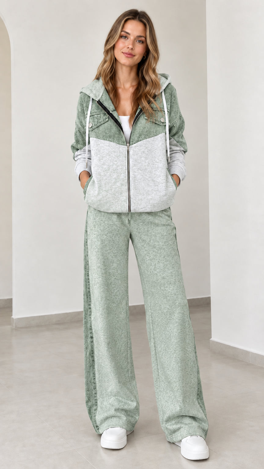 Model wearing sage green two-piece zip-up hoodie and wide-leg sweatpants set