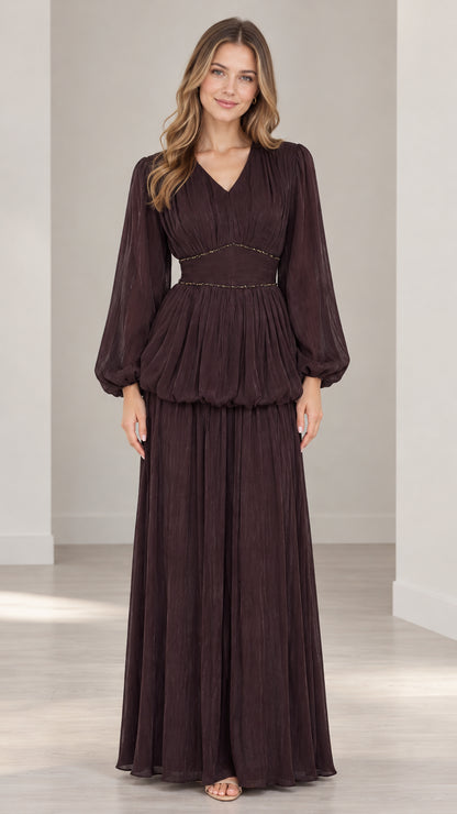 Front full-length view of woman wearing burgundy long sleeve pleated maxi dress