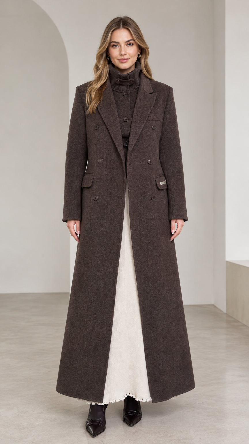 Front view of woman wearing dark brown floor-length double-breasted maxi coat