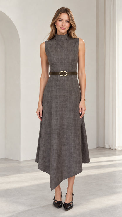 Front view of model wearing charcoal grey sleeveless mock neck midi dress with asymmetrical hem and belt
