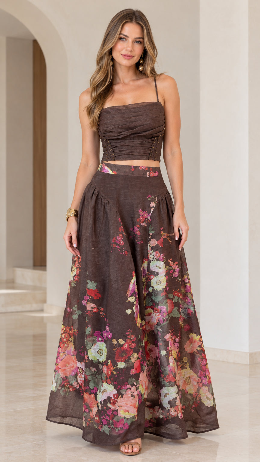 Front full view of woman wearing chocolate brown floral ruched crop top and maxi skirt set
