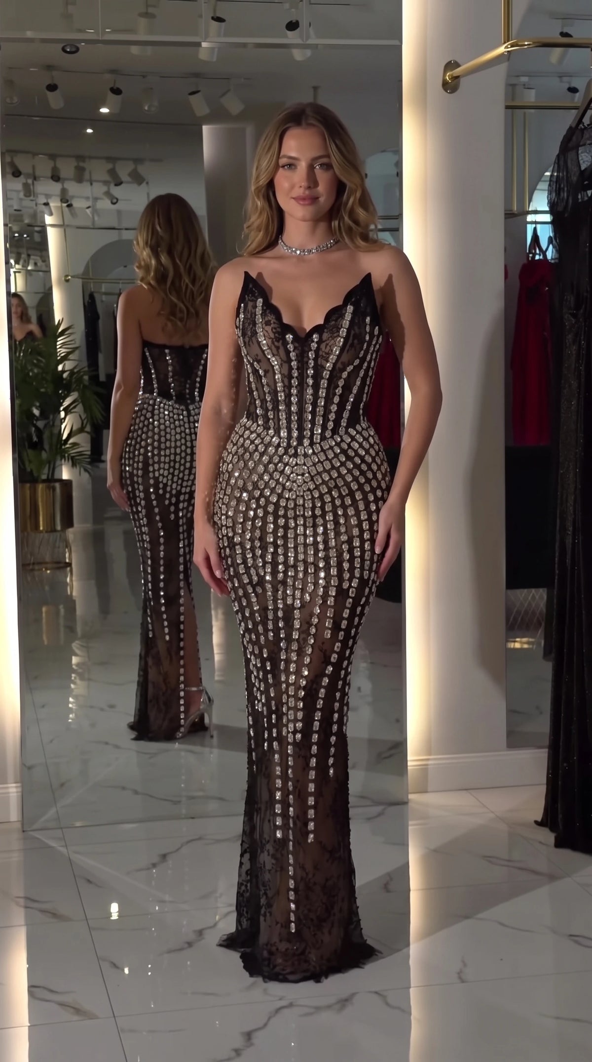 Front view of black crystal-embellished corset lace evening gown