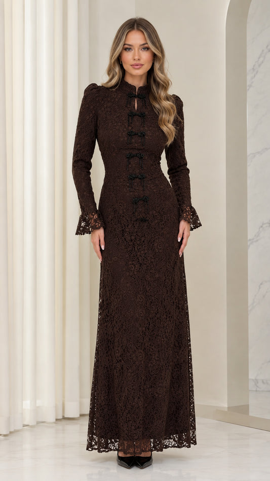 Front full view of woman wearing chocolate brown floral lace long-sleeve maxi dress with bow detailing