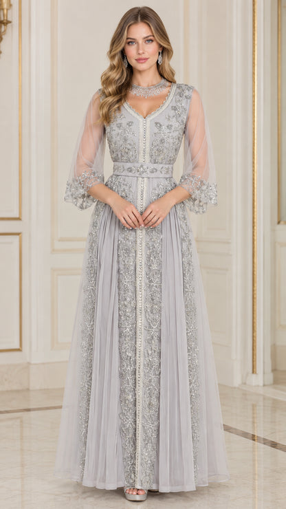 Front full-length view of woman in silver grey embroidered beaded V-neck evening gown