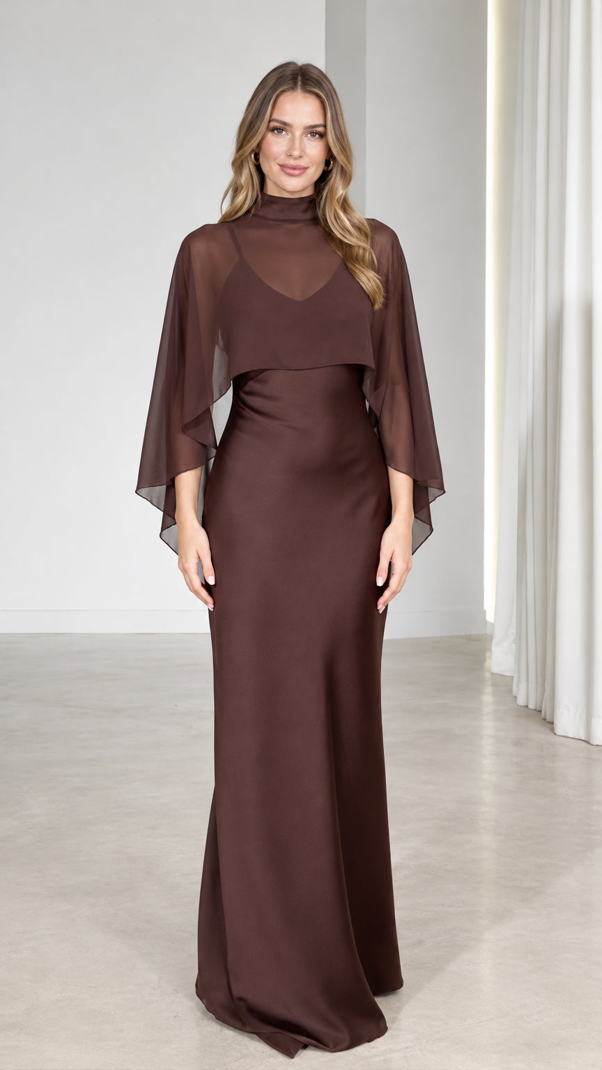 Front view of model wearing Chocolate Brown mock neck sheer capelet maxi dress