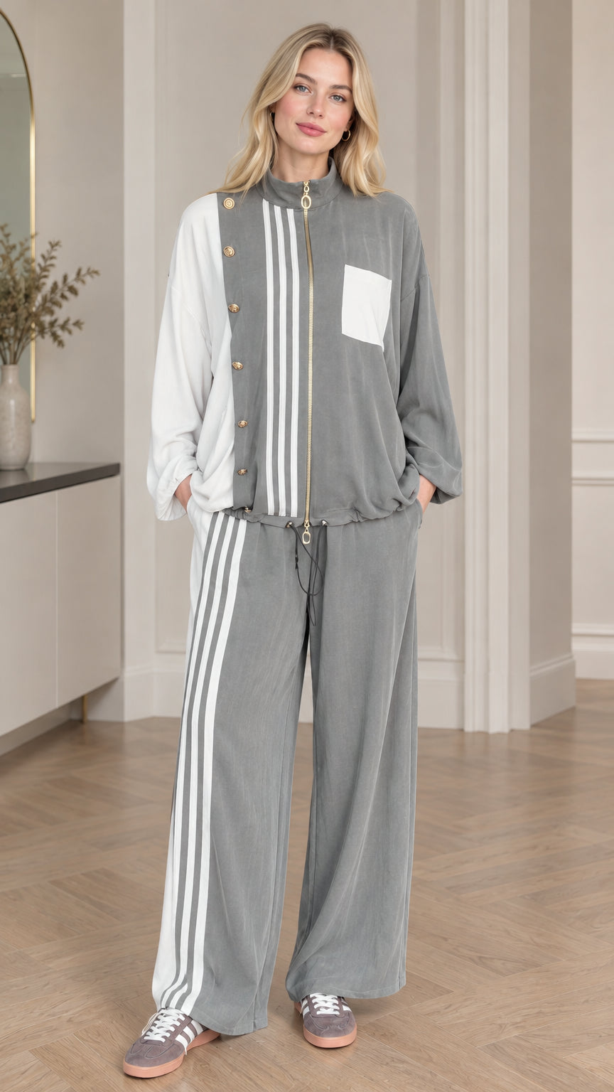 Front view of woman wearing grey and white colorblock zip-up jacket and wide leg pants set