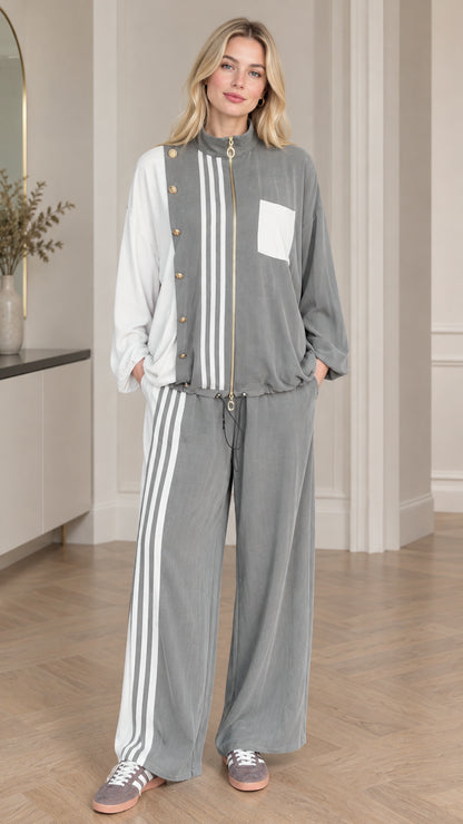 Front view of woman wearing grey and white colorblock zip-up jacket and wide leg pants set