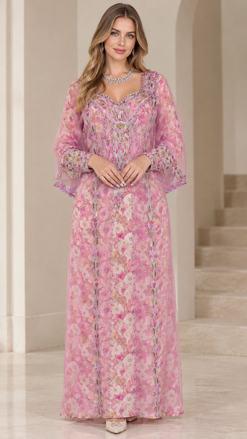 Front view of woman wearing pink floral embroidered kaftan maxi dress