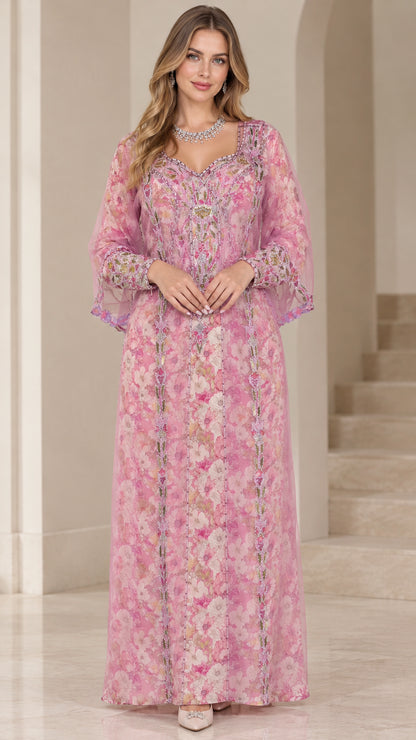 Front view of woman wearing pink floral embroidered kaftan maxi dress