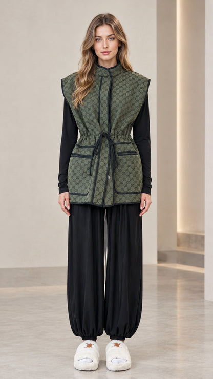 Front full view of woman wearing olive green monogram drawstring waist vest