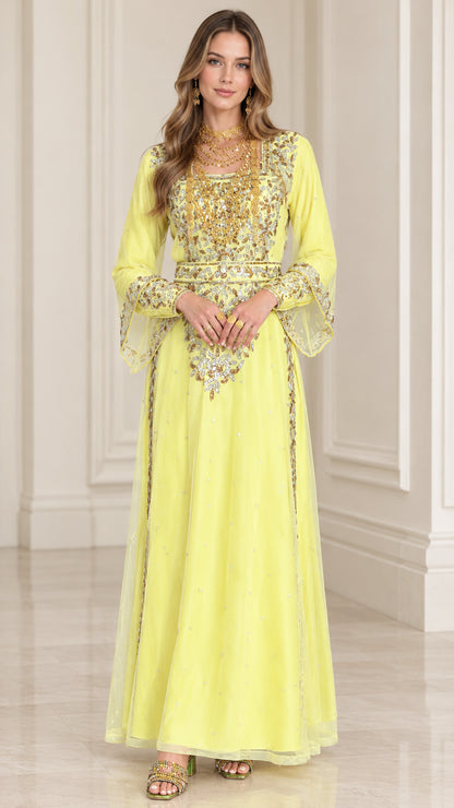 Front full-length view of woman wearing yellow embroidered kaftan maxi dress