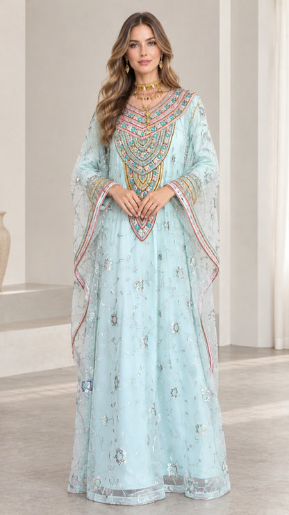 Front full-length view of woman wearing sky blue embroidered kaftan dress with sequin details