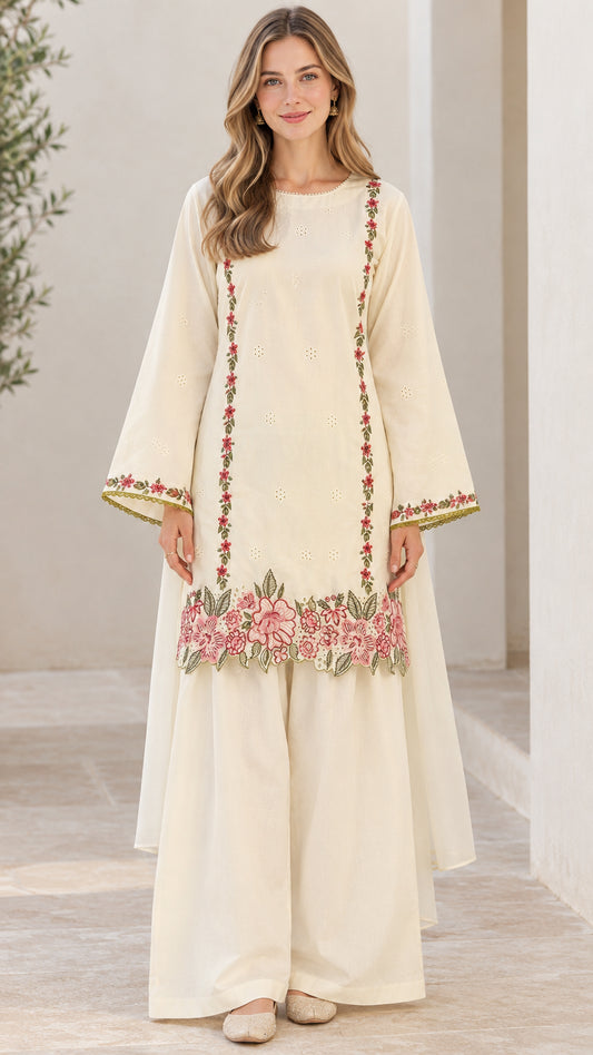 Front full-length view of woman wearing off-white embroidered tunic and wide-leg pants set