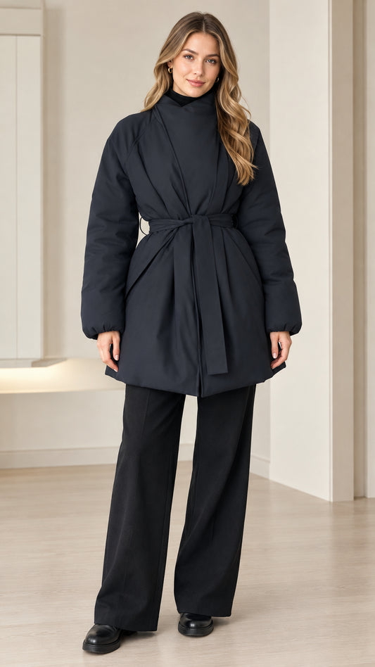 Front view of model wearing black wrap neck belted puffer jacket with wide leg pants