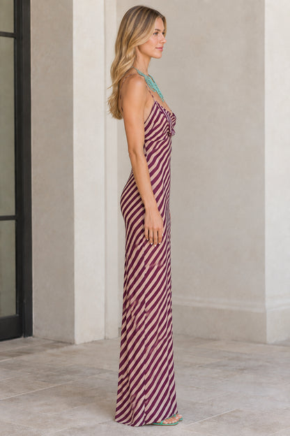 Side profile view of burgundy diagonal striped maxi slip dress