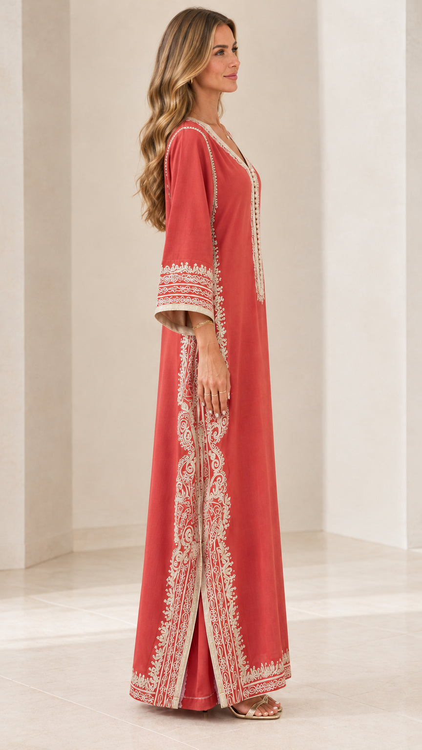 Side profile view of rust red embroidered maxi dress with side slit