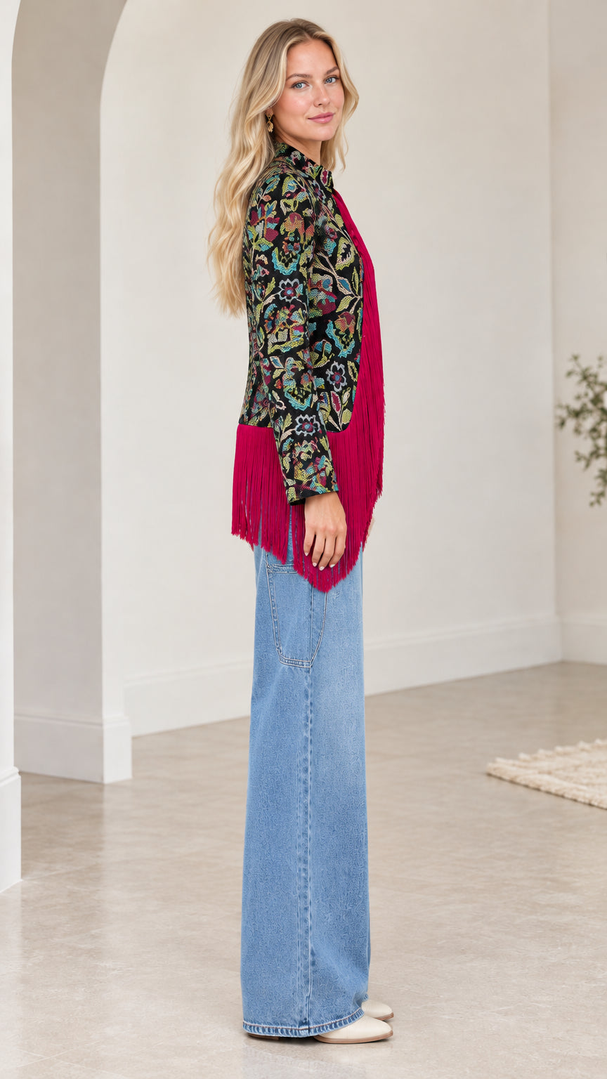 Side profile view of model showcasing sleeve length and fringe drape on floral jacquard jacket