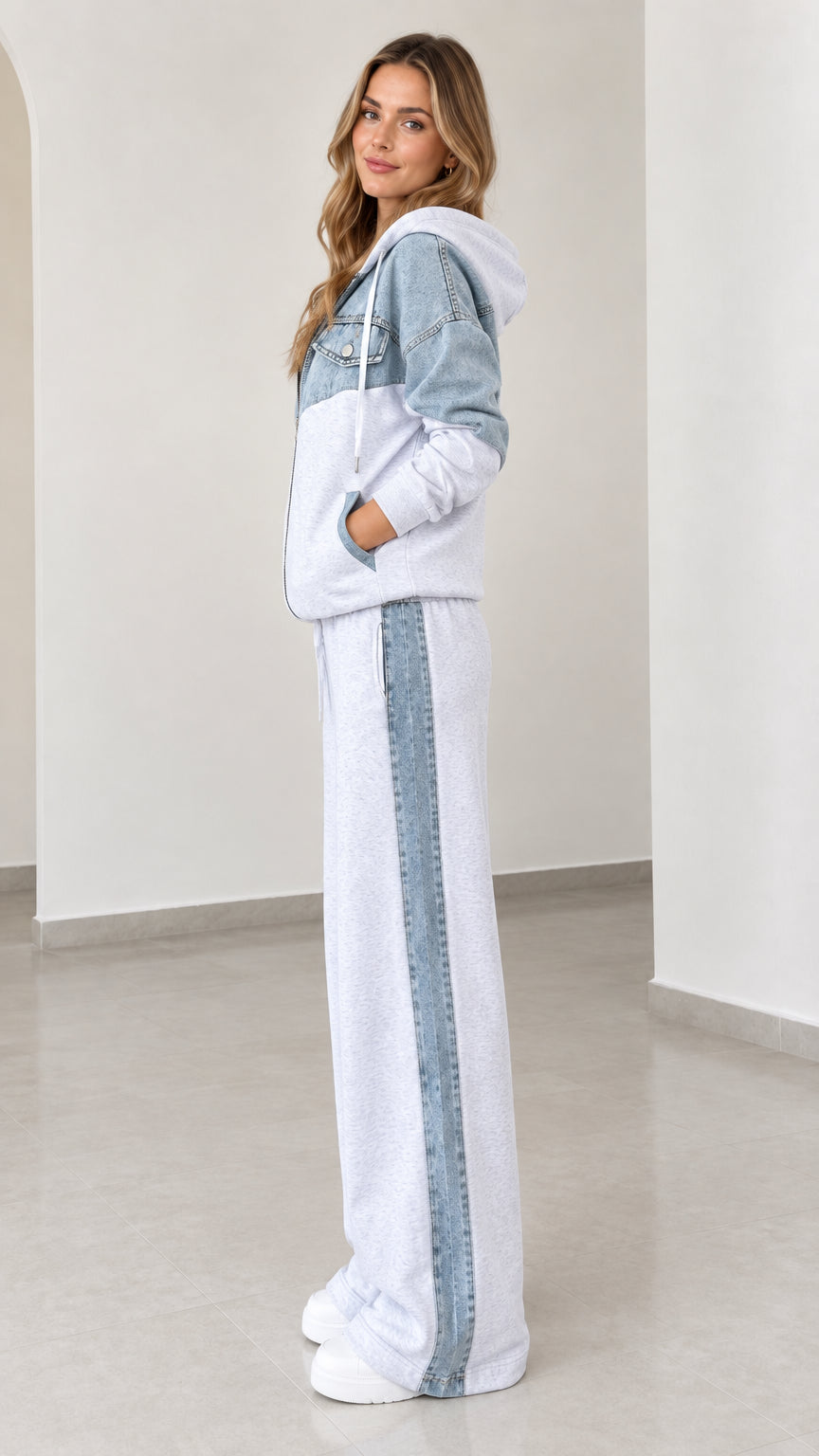 Side angle view of model wearing light grey and denim side-stripe wide-leg lounge set