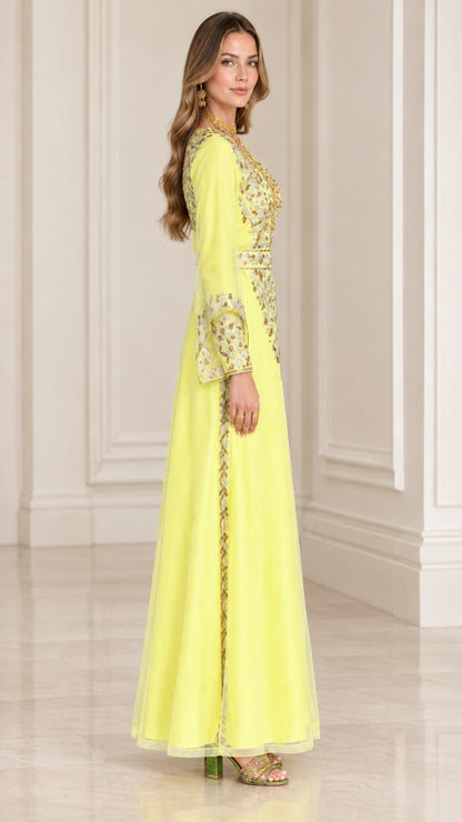 Side profile view of woman wearing yellow gold-embroidered evening gown