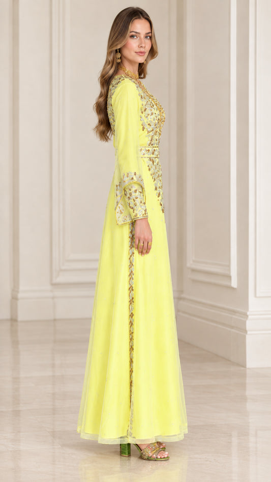 Side profile view of woman wearing yellow gold-embroidered evening gown