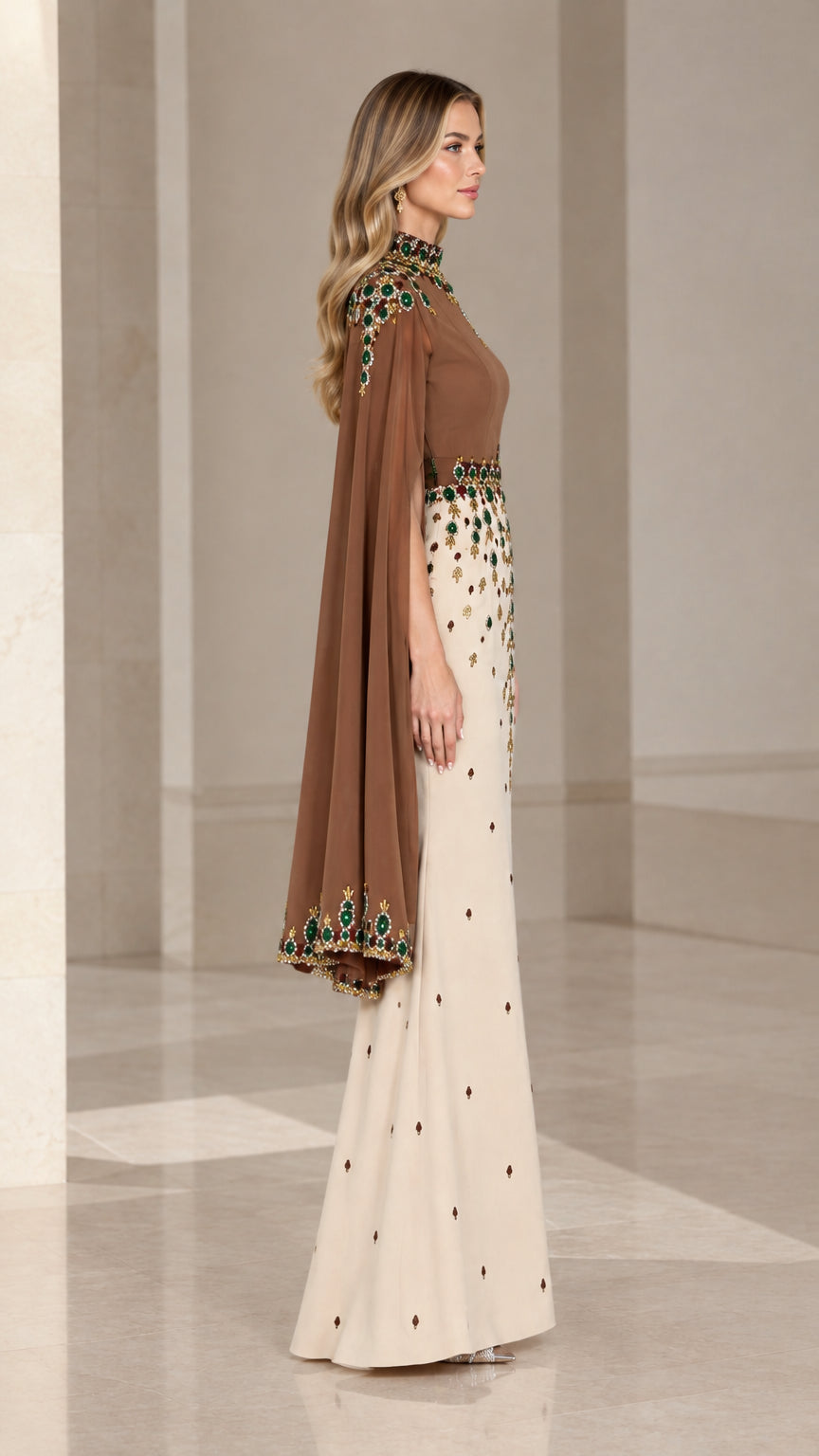 Side profile of elegant brown and cream cape evening gown showing flowing sleeve drape