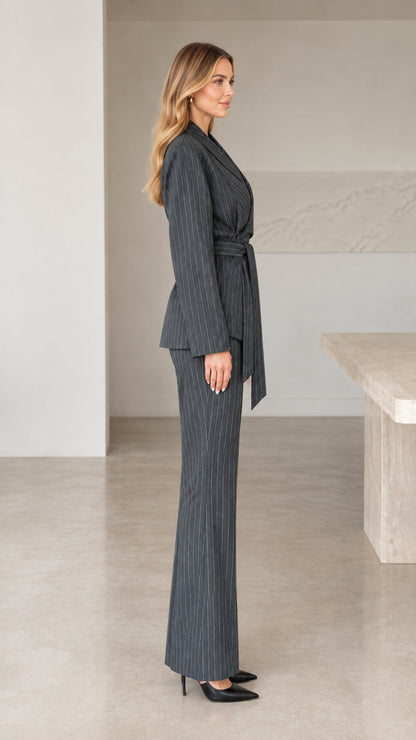 Side profile view of woman wearing charcoal grey tailored 2-piece pinstripe suit set