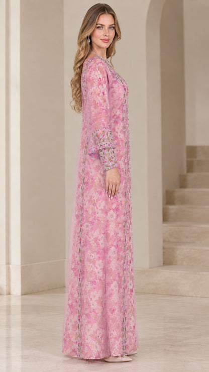 Side profile of woman wearing pink floral chiffon kaftan dress