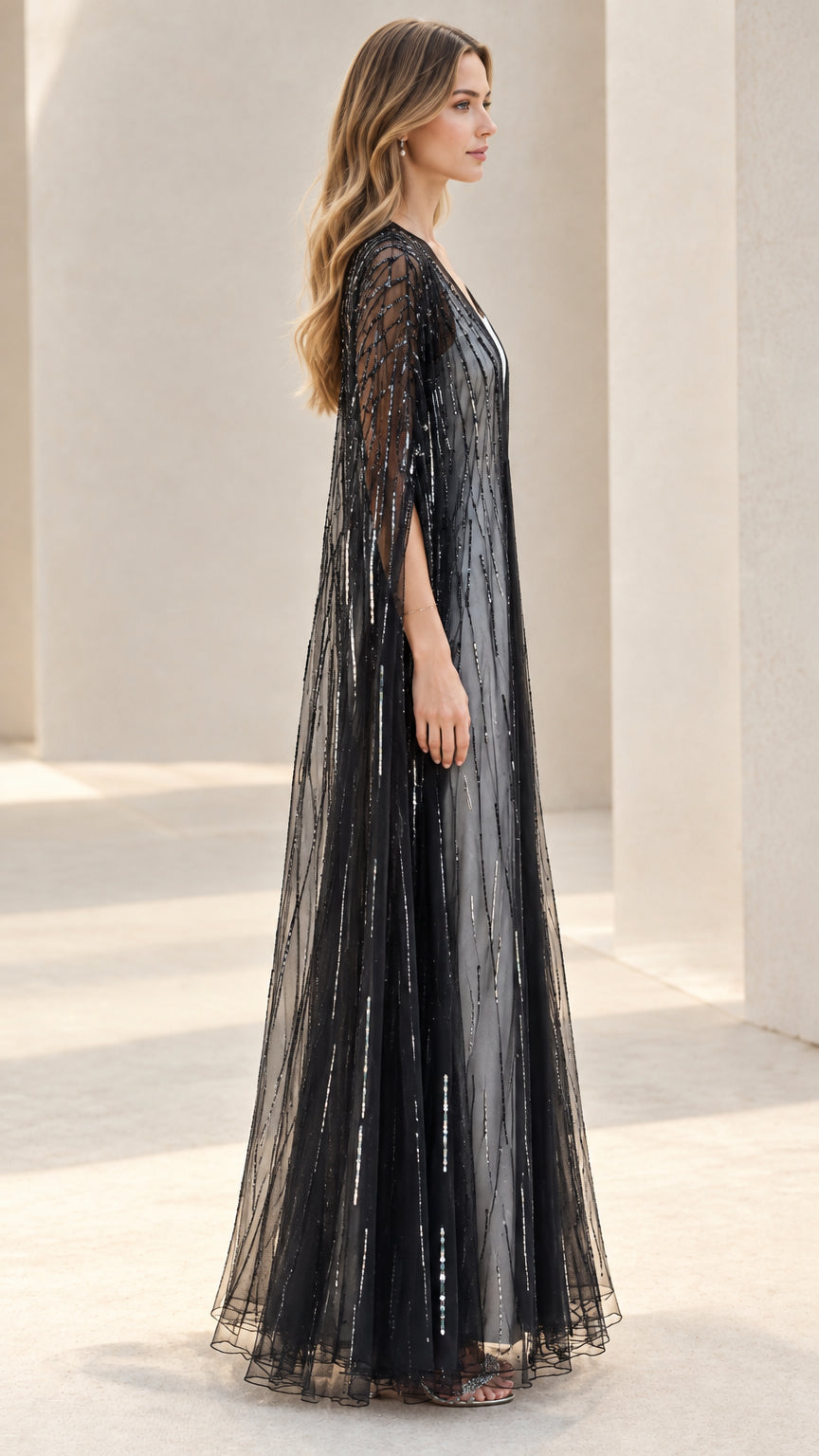 Side profile view of black sheer sequined maxi cape duster