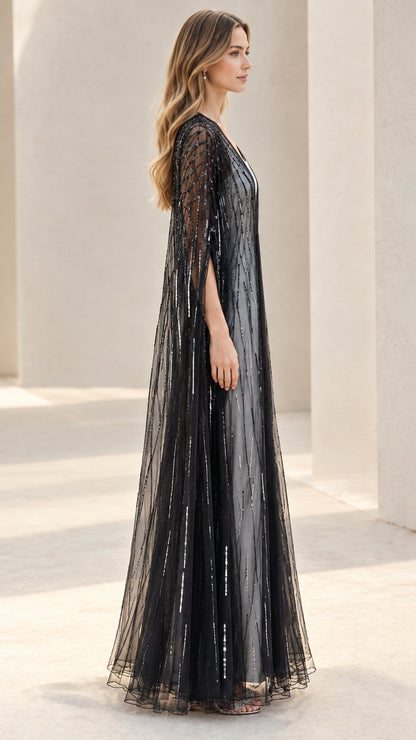 Side profile view of black sheer sequined maxi cape duster
