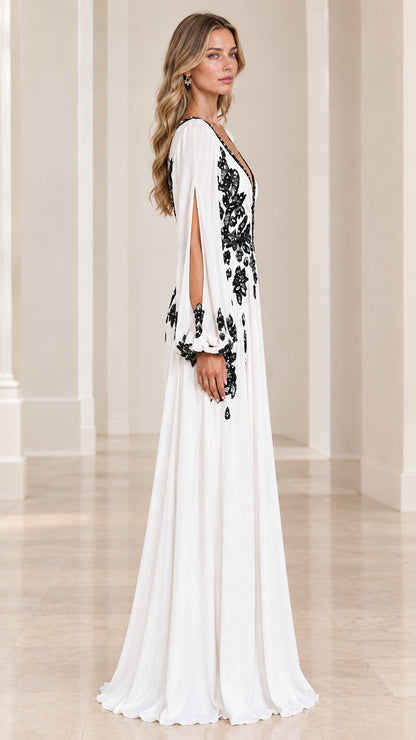 Side profile of model wearing white floor-length embroidered evening dress
